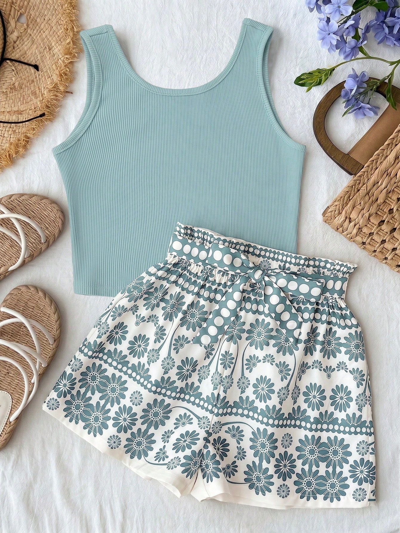 Tween girl summer two-piece outfit featuring a white scoop neck tank top and green ditsy floral print paperbag waist shorts with belt.