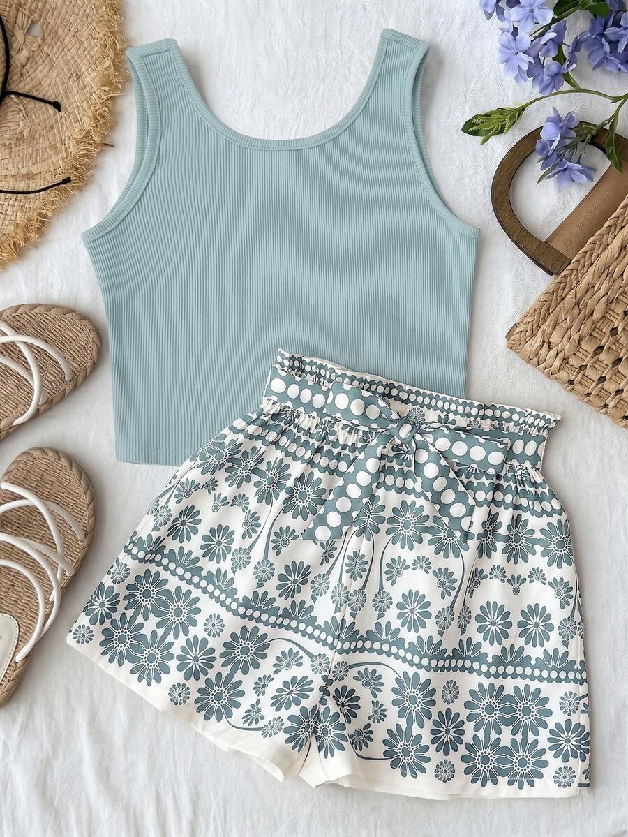 Tween girl summer two-piece outfit featuring a white scoop neck tank top and green ditsy floral print paperbag waist shorts with belt.
