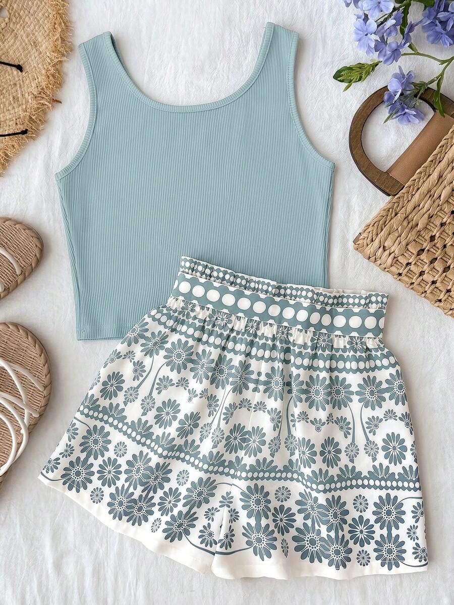 Tween girl summer two-piece outfit featuring a white scoop neck tank top and green ditsy floral print paperbag waist shorts with belt.