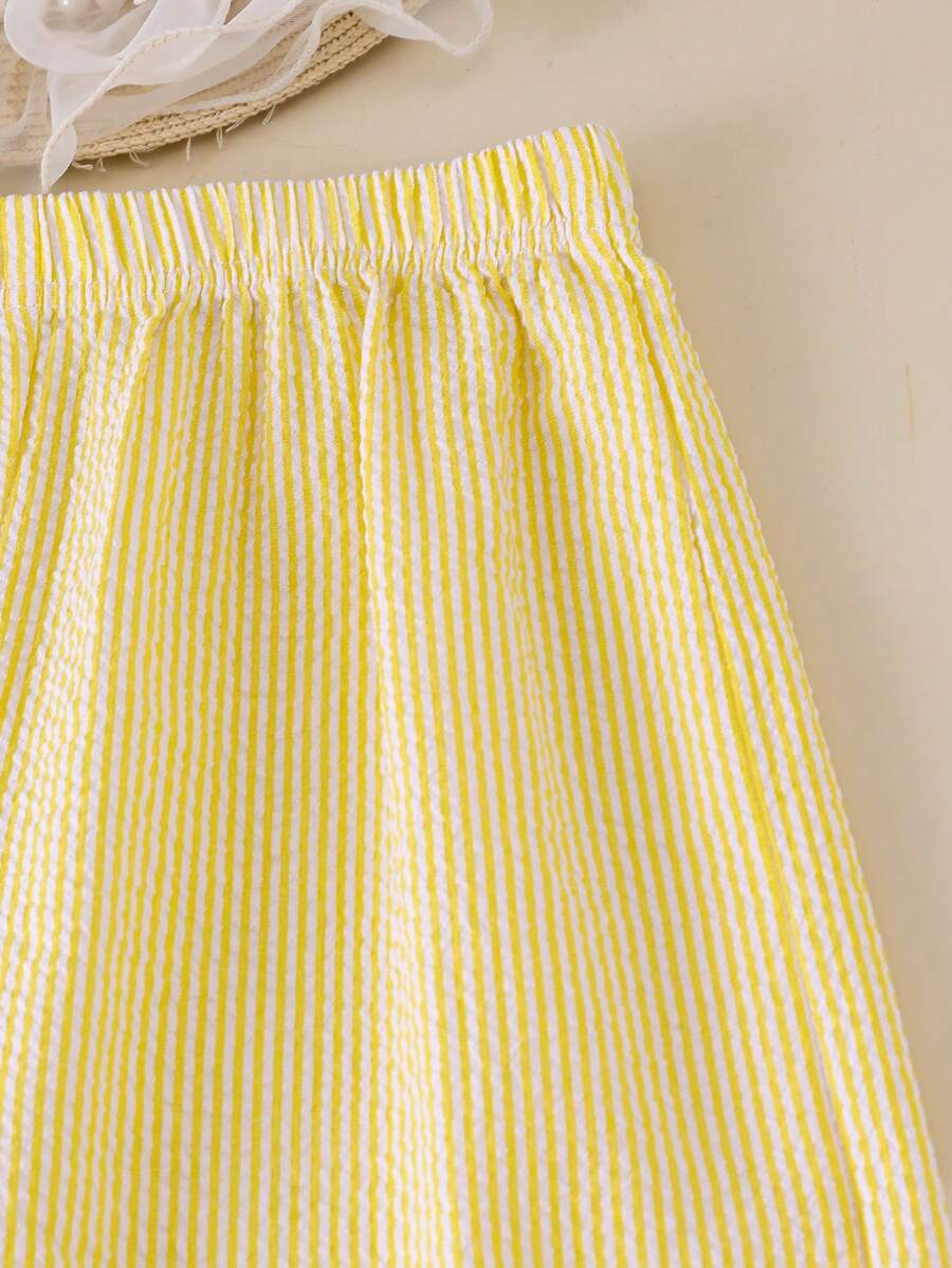 Tween girls blue 2-piece vacation outfit set featuring a tiered ruffle spaghetti strap camisole and loose high-waist pants.