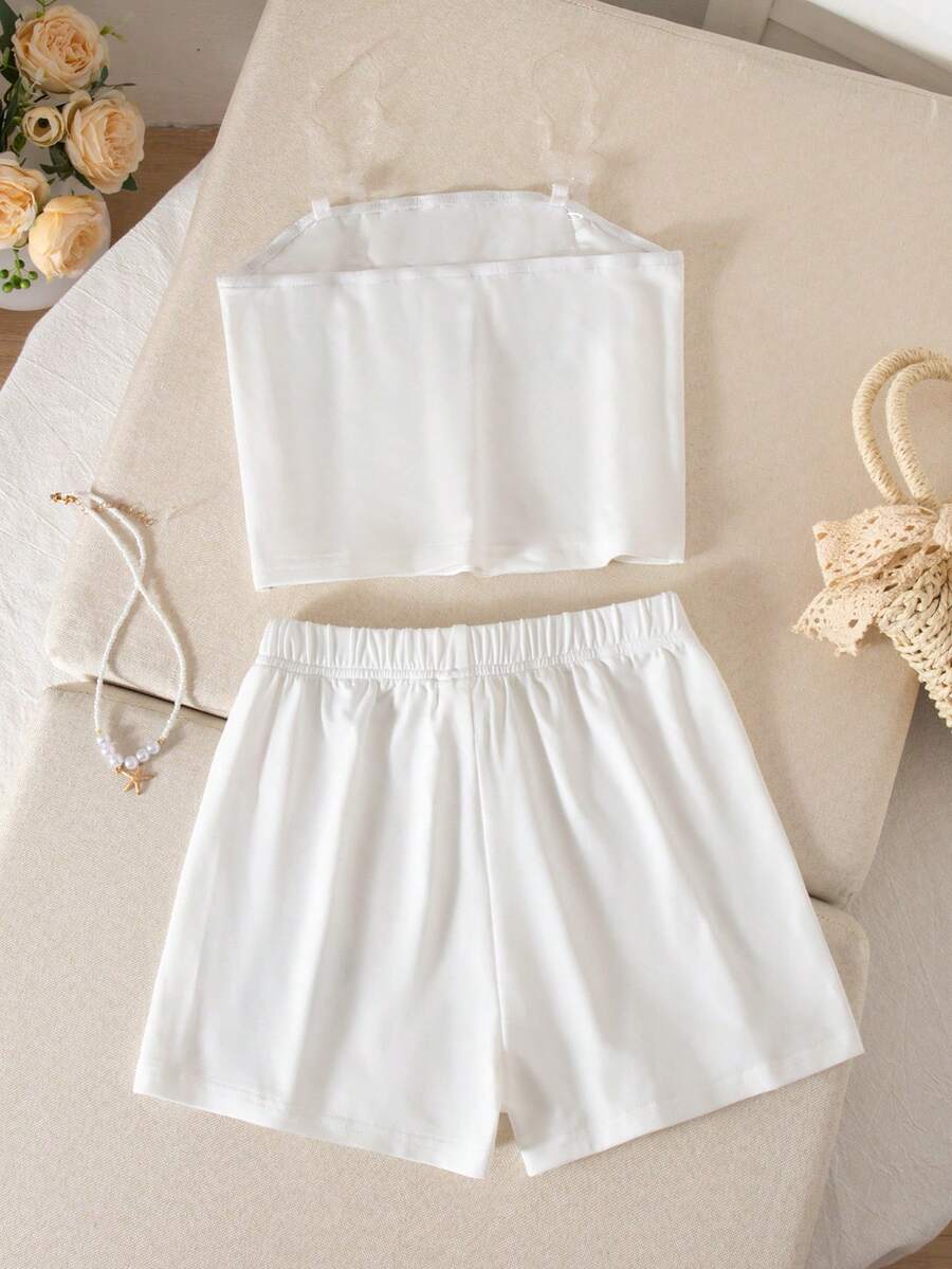 Tween girls summer 2-piece Hawaiian style outfit featuring a graphic print spaghetti strap camisole top with contrast piping and matching casual shorts.