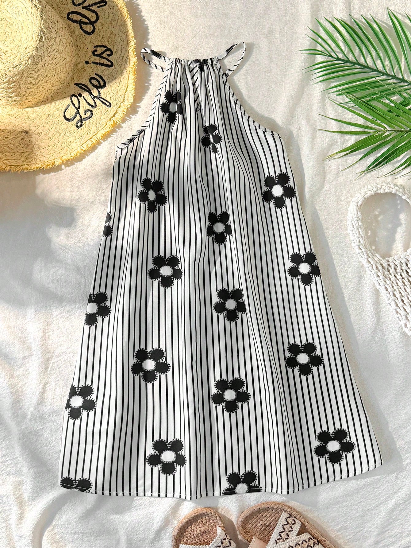 Tween girls floral print dress with halter neckline, sleeveless cold shoulder design, A-line shape, and vacation style.