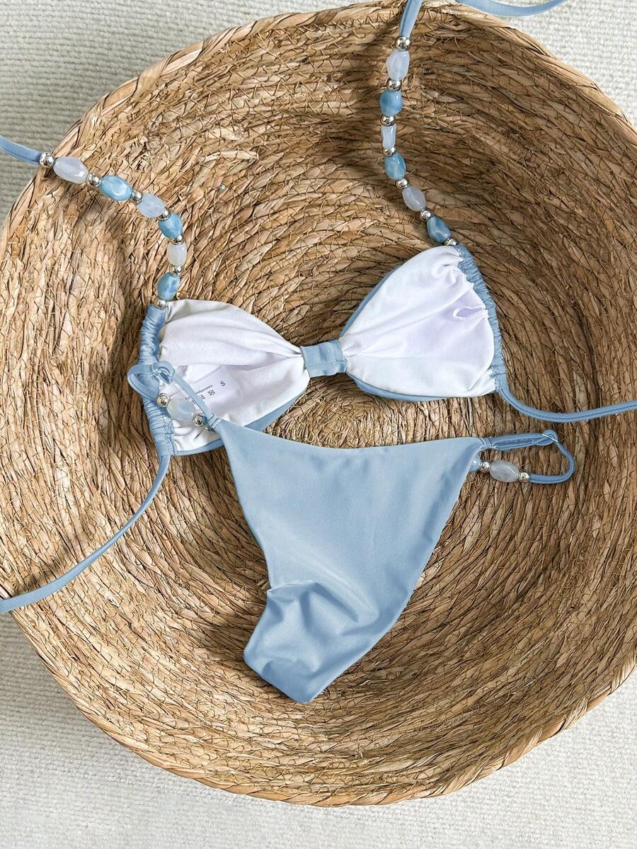 Women's green halter neck bikini set featuring color-block beaded shoulder straps, back tie detail, and high cut bottoms.