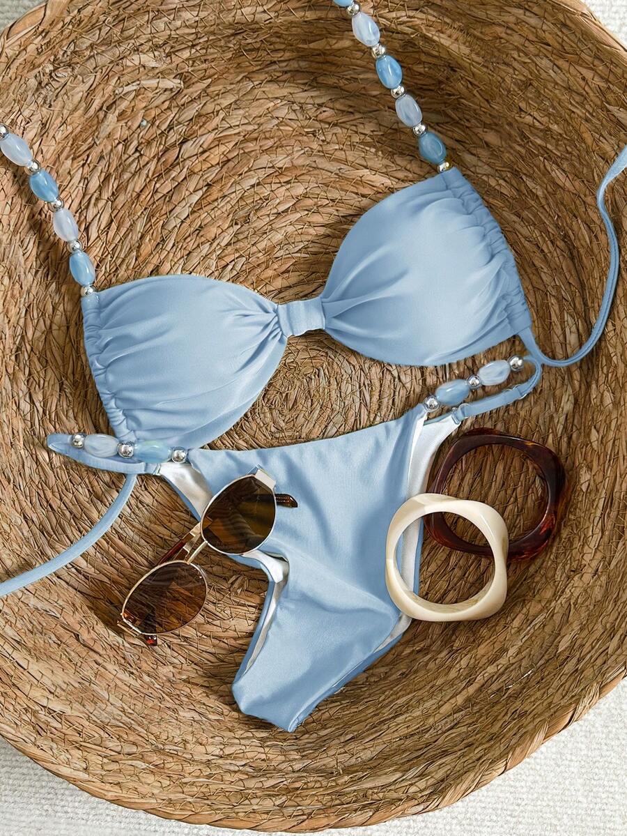 Women's green halter neck bikini set featuring color-block beaded shoulder straps, back tie detail, and high cut bottoms.