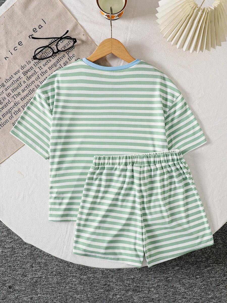 Tween girl wearing a black and white striped drop-shoulder crew neck t-shirt with bow embroidery paired with matching tie-waist shorts.