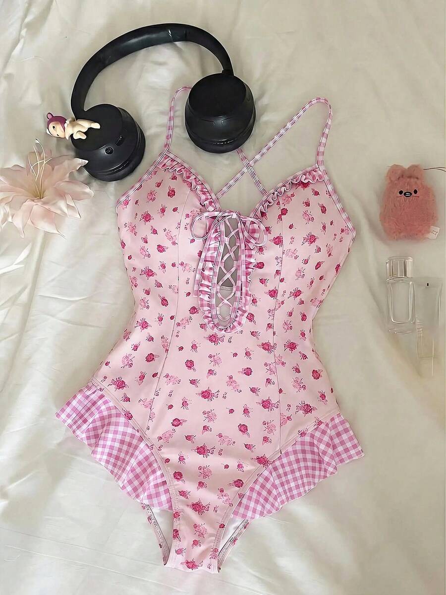 Women's strawberry print one-piece swimsuit featuring ruffle details, front-tie design, backless criss-cross straps, and triangle wireless cups.