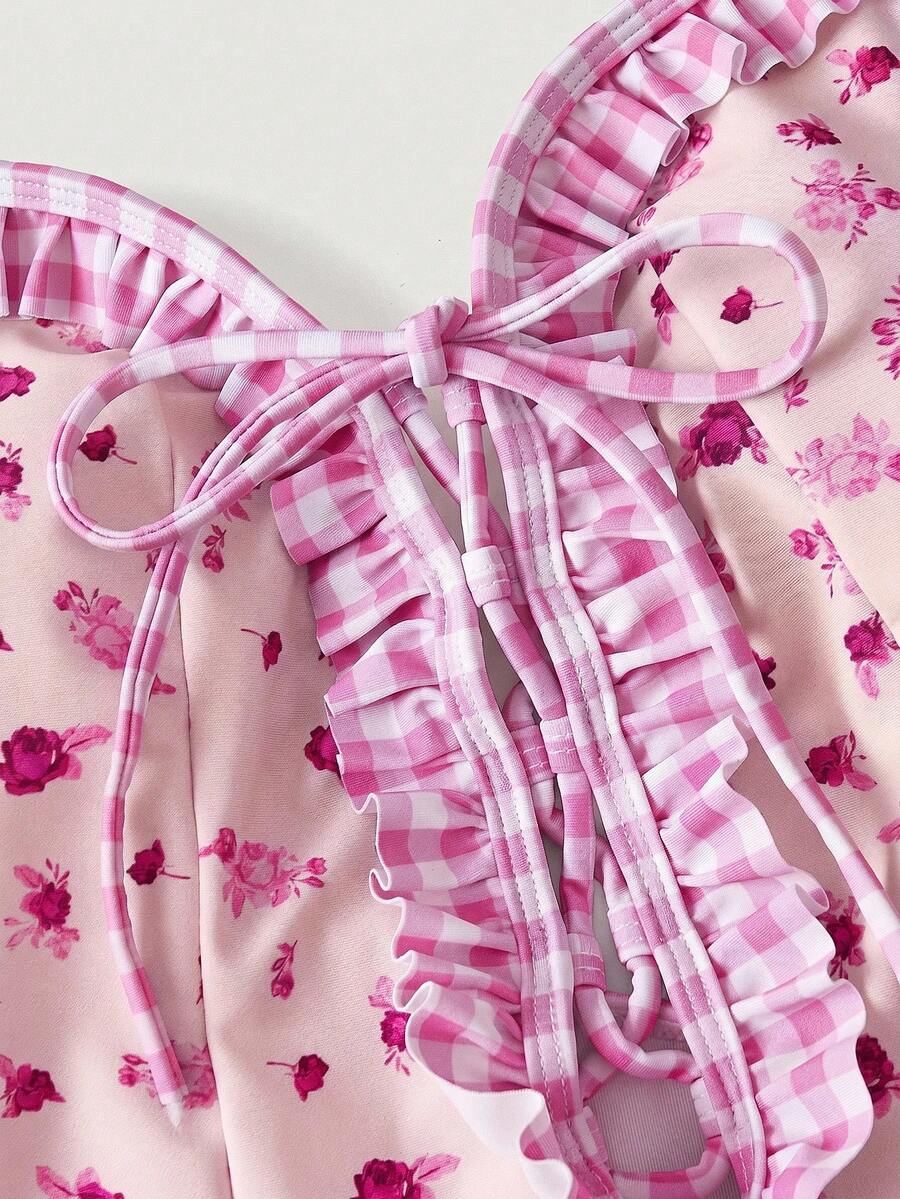 Women's strawberry print one-piece swimsuit featuring ruffle details, front-tie design, backless criss-cross straps, and triangle wireless cups.
