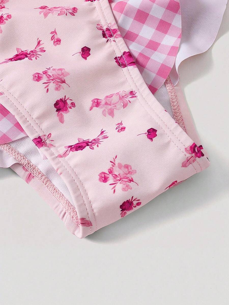 Women's strawberry print one-piece swimsuit featuring ruffle details, front-tie design, backless criss-cross straps, and triangle wireless cups.