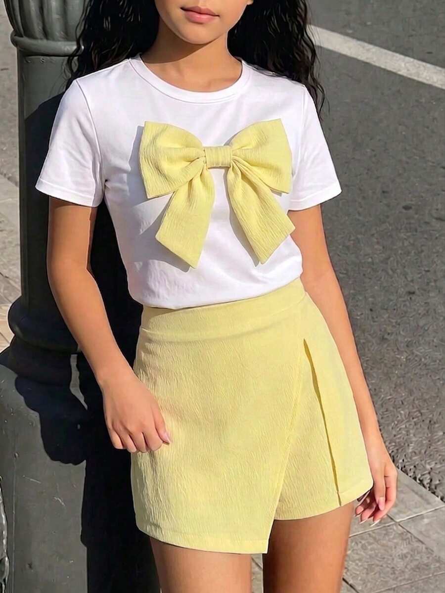 Tween girls 2-piece blue outfit featuring a short sleeve round neck t-shirt with a bow front detail and an asymmetric wrap skort.