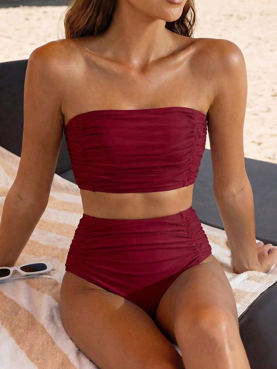 Women's black strapless ruched bandeau bikini top with high waisted bottoms