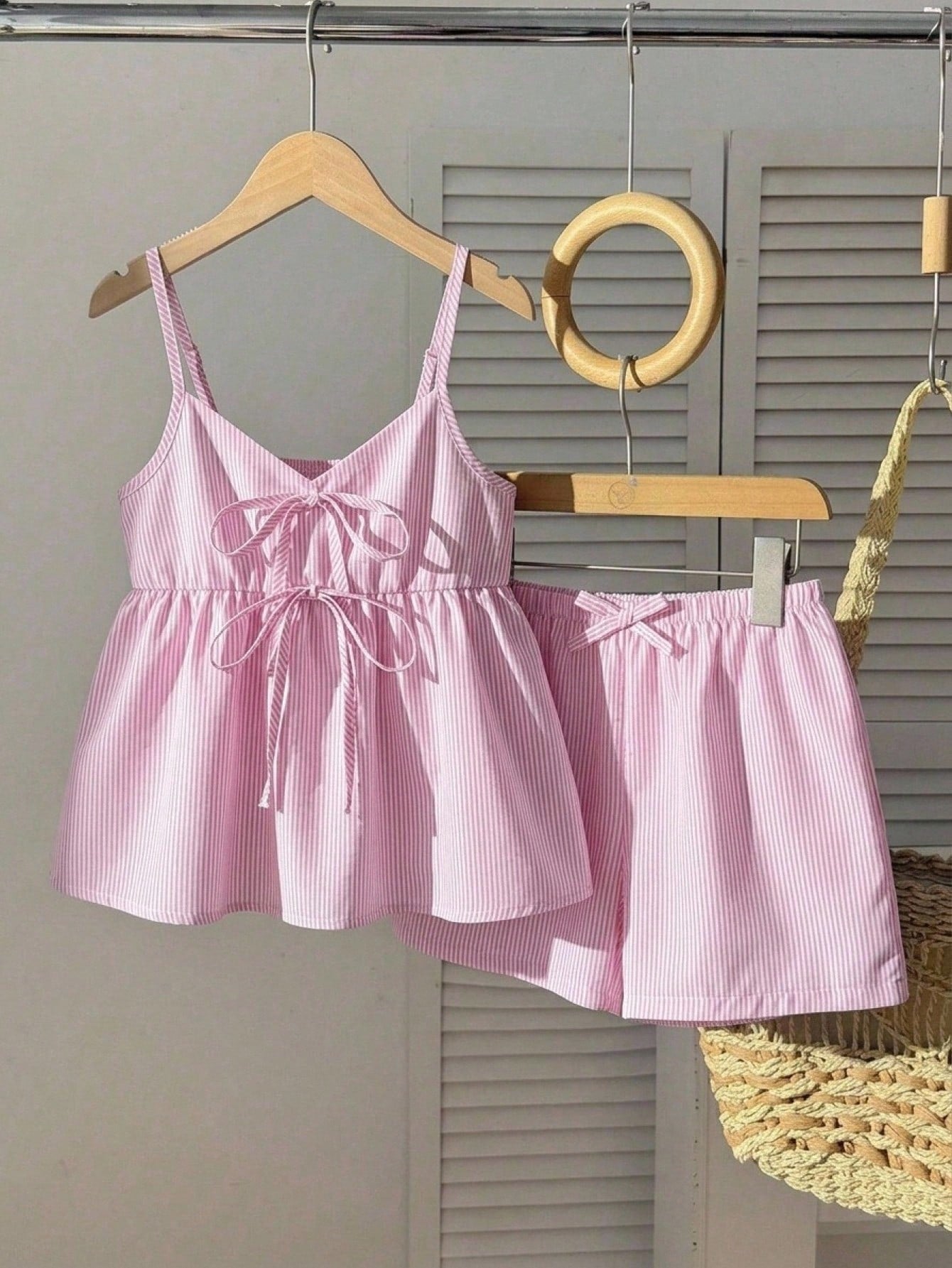 Tween girl 2-piece summer set with a black and white sleeveless striped spaghetti strap tank top with ruffle details and matching casual shorts.