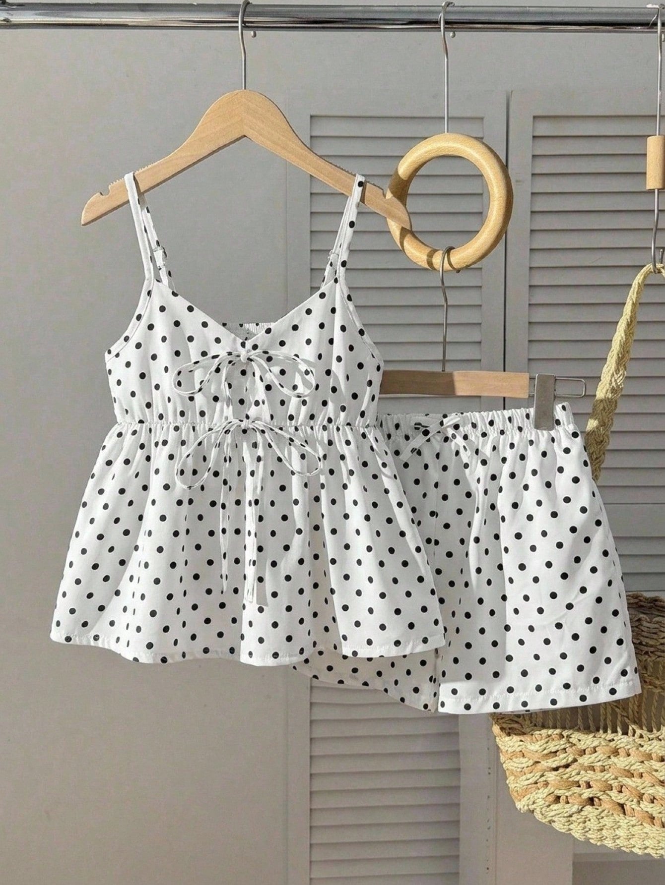 Tween girl 2-piece summer set with a black and white sleeveless striped spaghetti strap tank top with ruffle details and matching casual shorts.