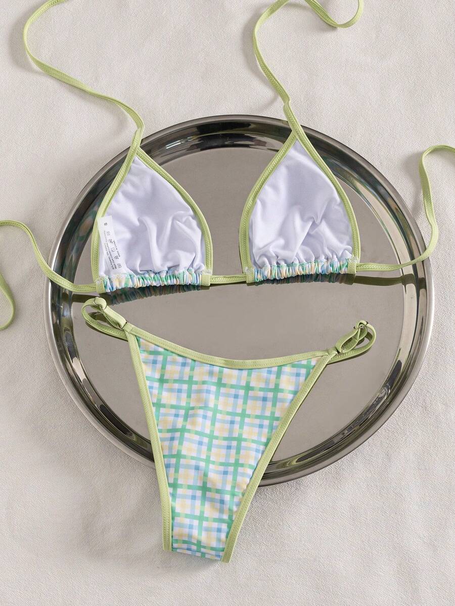 Multicolor bohemian bikini set for women featuring a backless halter top with knot details and high cut swimsuit bottoms.