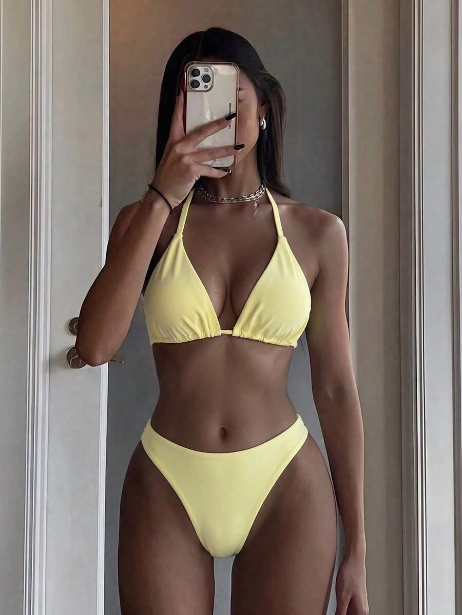 Women's two-piece halter bikini set featuring high cut thong bottoms and removable padding