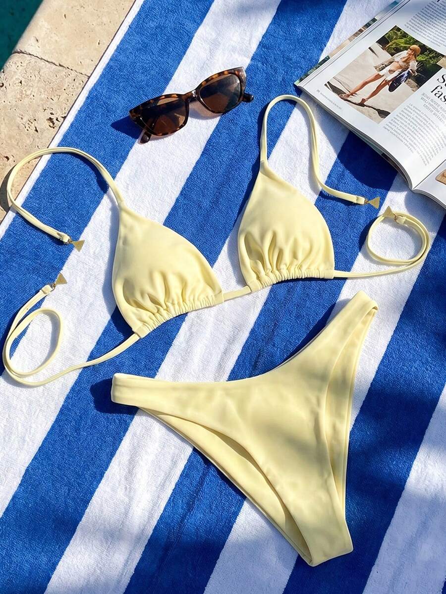 Women's two-piece halter bikini set featuring high cut thong bottoms and removable padding