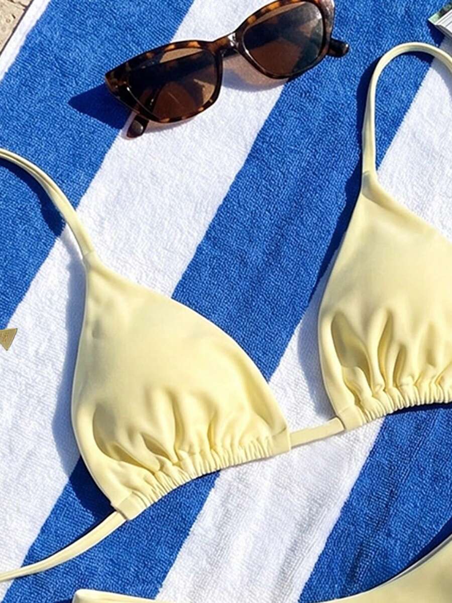 Women's two-piece halter bikini set featuring high cut thong bottoms and removable padding