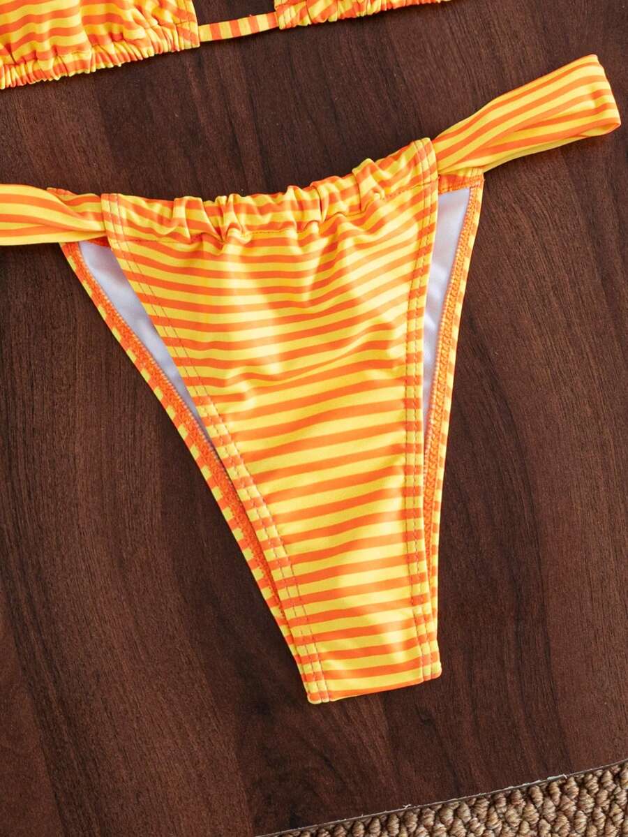 Women's striped halter two-piece swimsuit featuring a lace-up triangle top with removable padding and high-cut low-waist bikini bottoms.