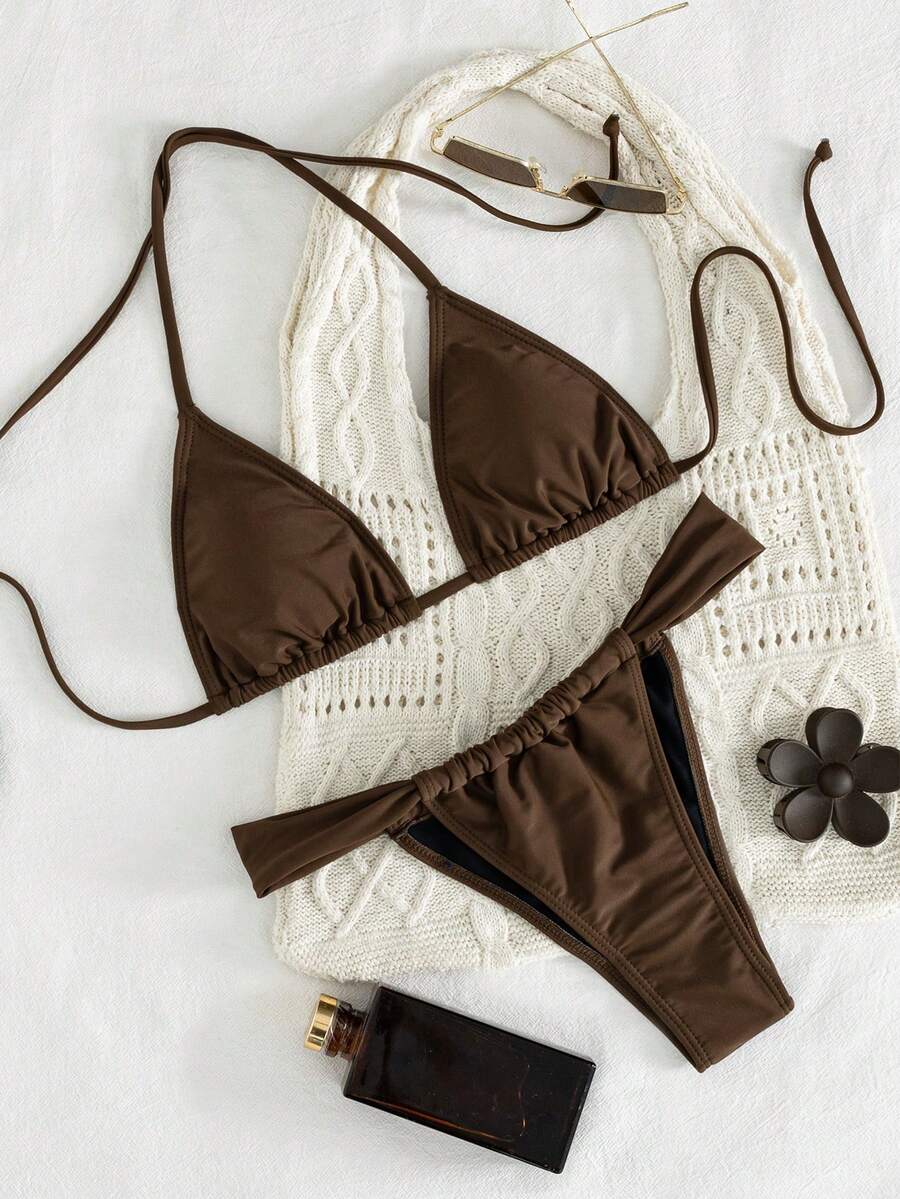 Women's striped halter two-piece swimsuit featuring a lace-up triangle top with removable padding and high-cut low-waist bikini bottoms.