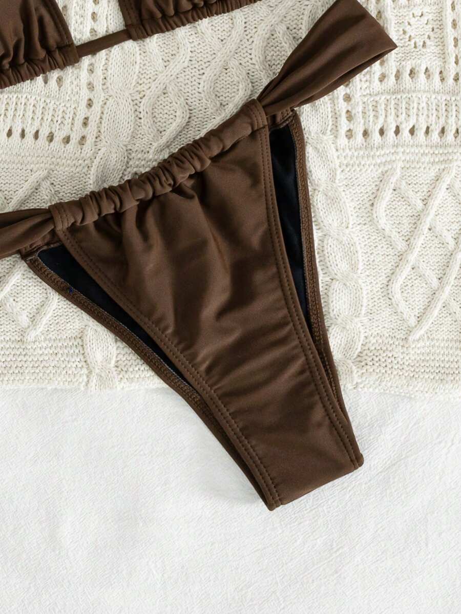 Women's striped halter two-piece swimsuit featuring a lace-up triangle top with removable padding and high-cut low-waist bikini bottoms.