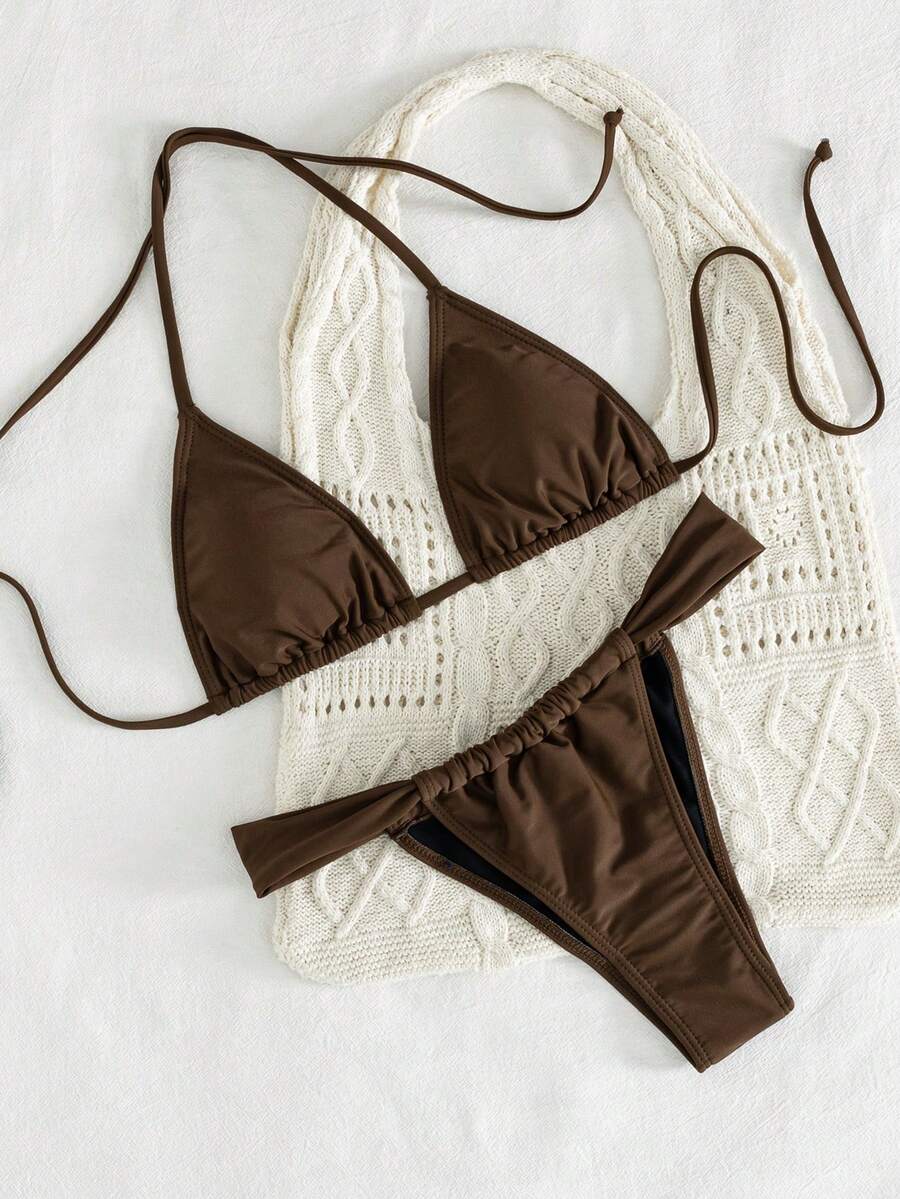 Women's striped halter two-piece swimsuit featuring a lace-up triangle top with removable padding and high-cut low-waist bikini bottoms.