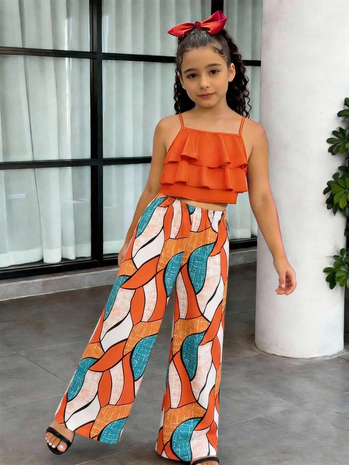 Tween girls blue 2-piece vacation outfit set featuring a tiered ruffle spaghetti strap camisole and loose high-waist pants.