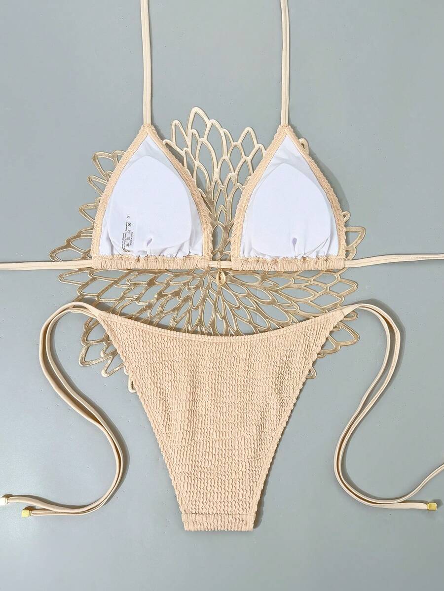 Women's black two-piece bikini set featuring a halter neck with a colorful sun pendant, triangle cups, and high-cut tie-side bottoms.