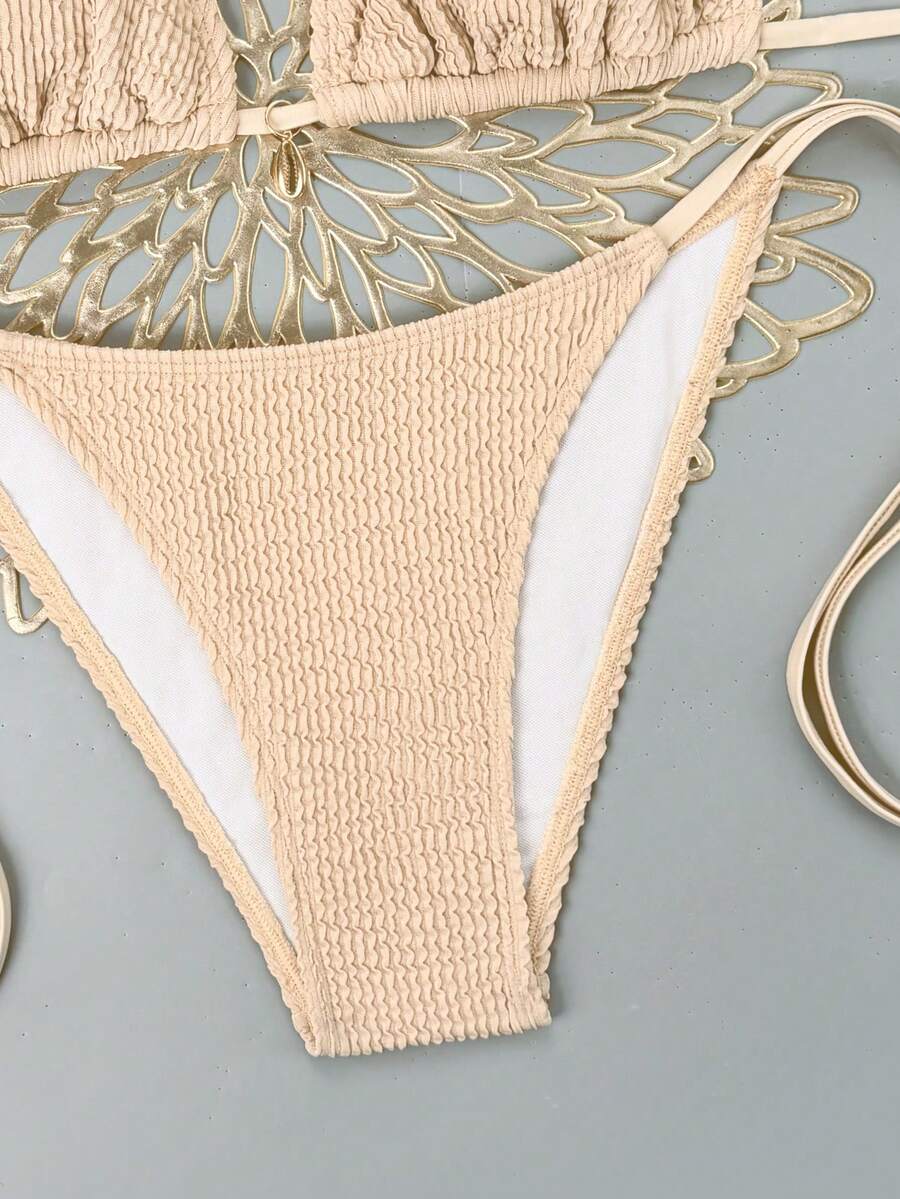 Women's black two-piece bikini set featuring a halter neck with a colorful sun pendant, triangle cups, and high-cut tie-side bottoms.