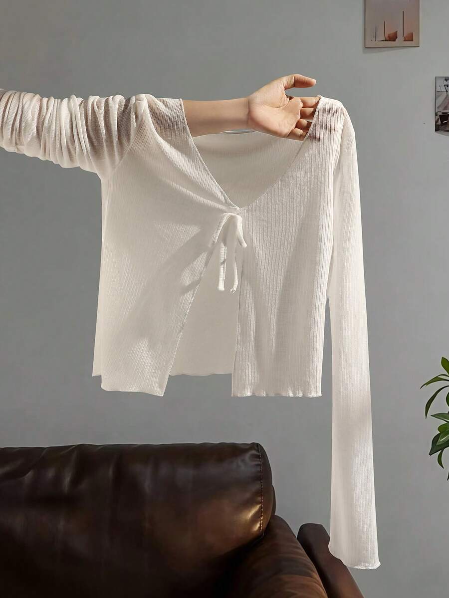Tween girls white long sleeve V-neck cardigan top featuring asymmetrical front buttons.