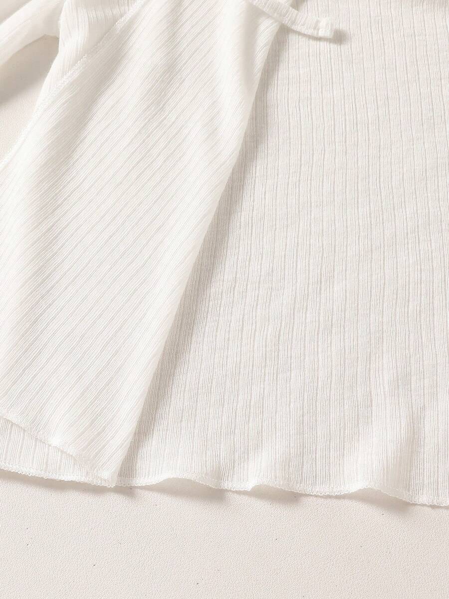 Tween girls white long sleeve V-neck cardigan top featuring asymmetrical front buttons.