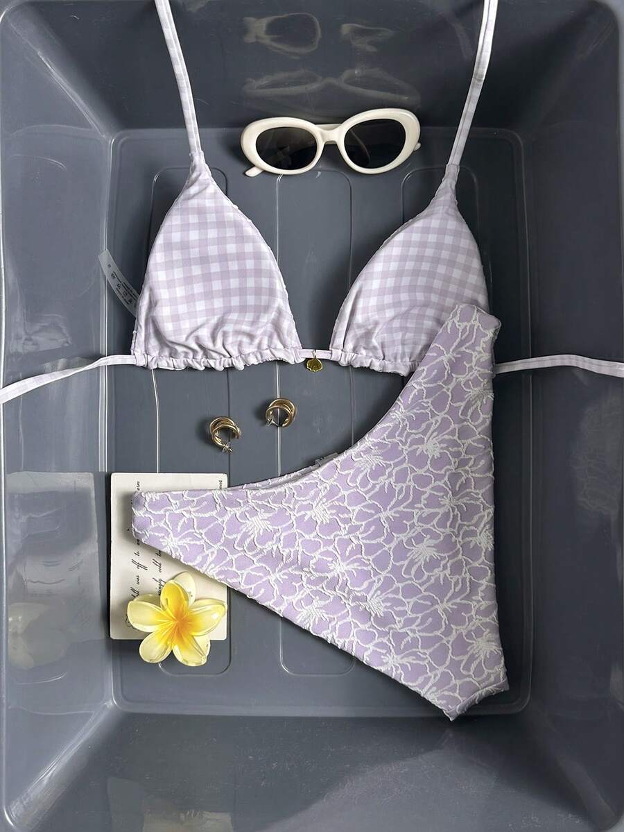 Women's black textured plaid 2-piece bikini set featuring a halter neckline, wireless triangle cups with removable padding, and mid-waist bottoms.