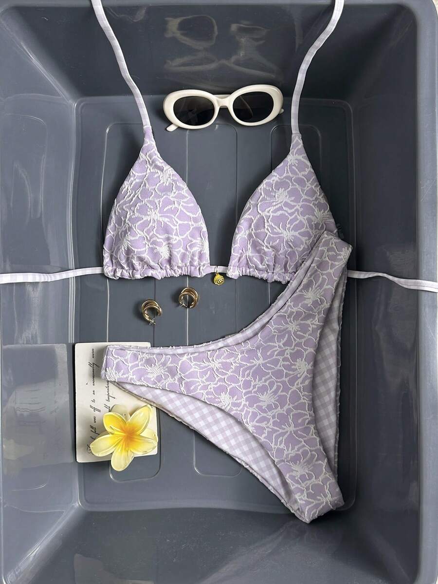 Women's black textured plaid 2-piece bikini set featuring a halter neckline, wireless triangle cups with removable padding, and mid-waist bottoms.