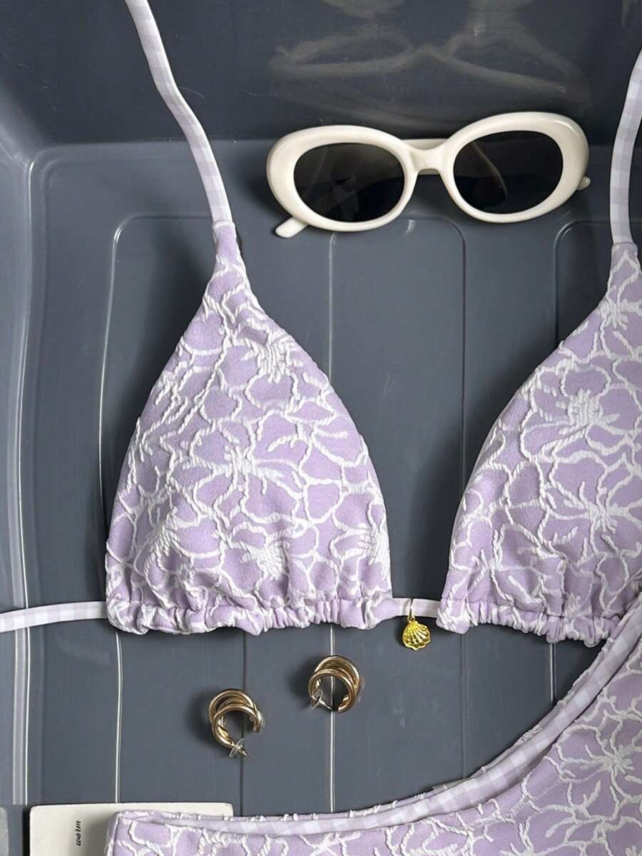 Women's black textured plaid 2-piece bikini set featuring a halter neckline, wireless triangle cups with removable padding, and mid-waist bottoms.