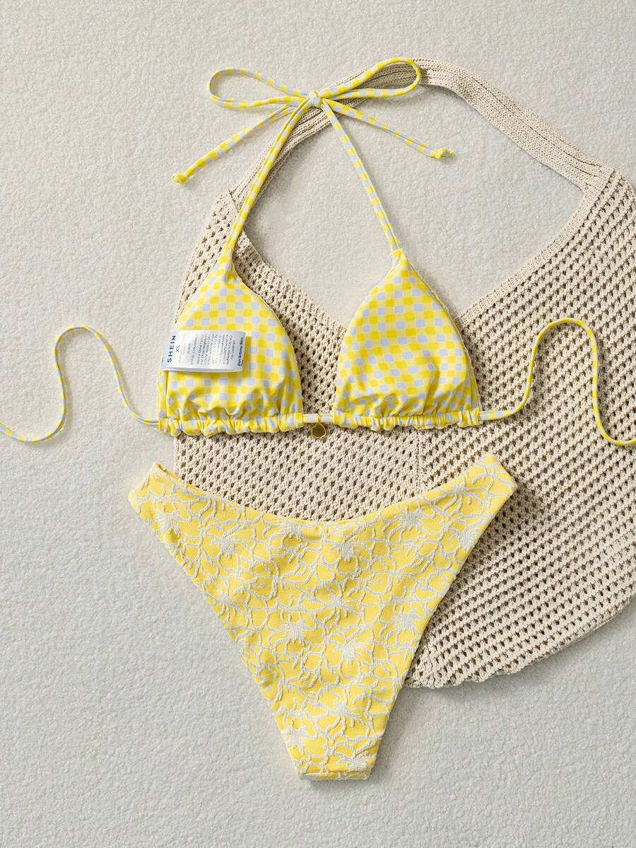 Women's black textured plaid 2-piece bikini set featuring a halter neckline, wireless triangle cups with removable padding, and mid-waist bottoms.
