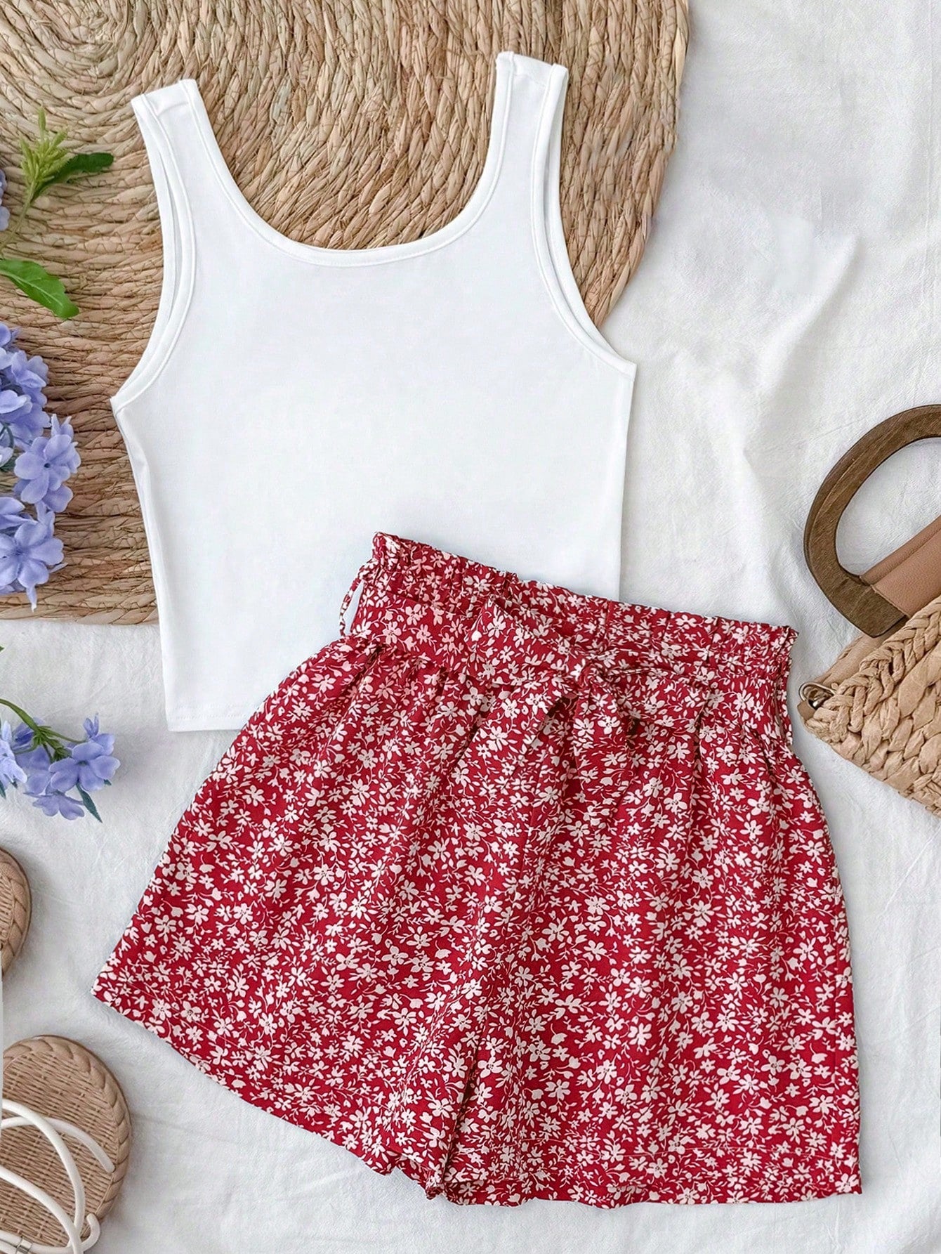 Tween girl summer two-piece outfit featuring a white scoop neck tank top and green ditsy floral print paperbag waist shorts with belt.