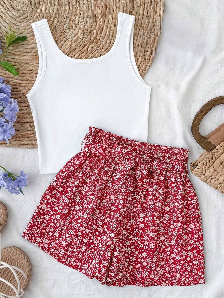 Tween girl summer two-piece outfit featuring a white scoop neck tank top and green ditsy floral print paperbag waist shorts with belt.