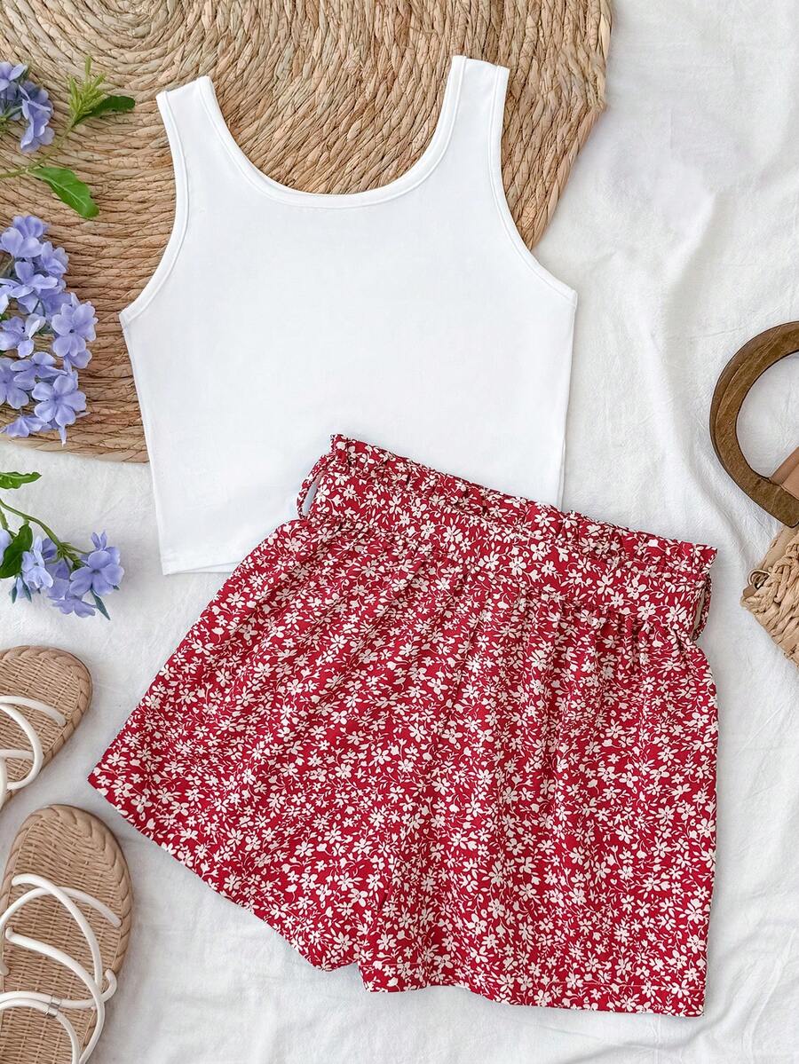 Tween girl summer two-piece outfit featuring a white scoop neck tank top and green ditsy floral print paperbag waist shorts with belt.