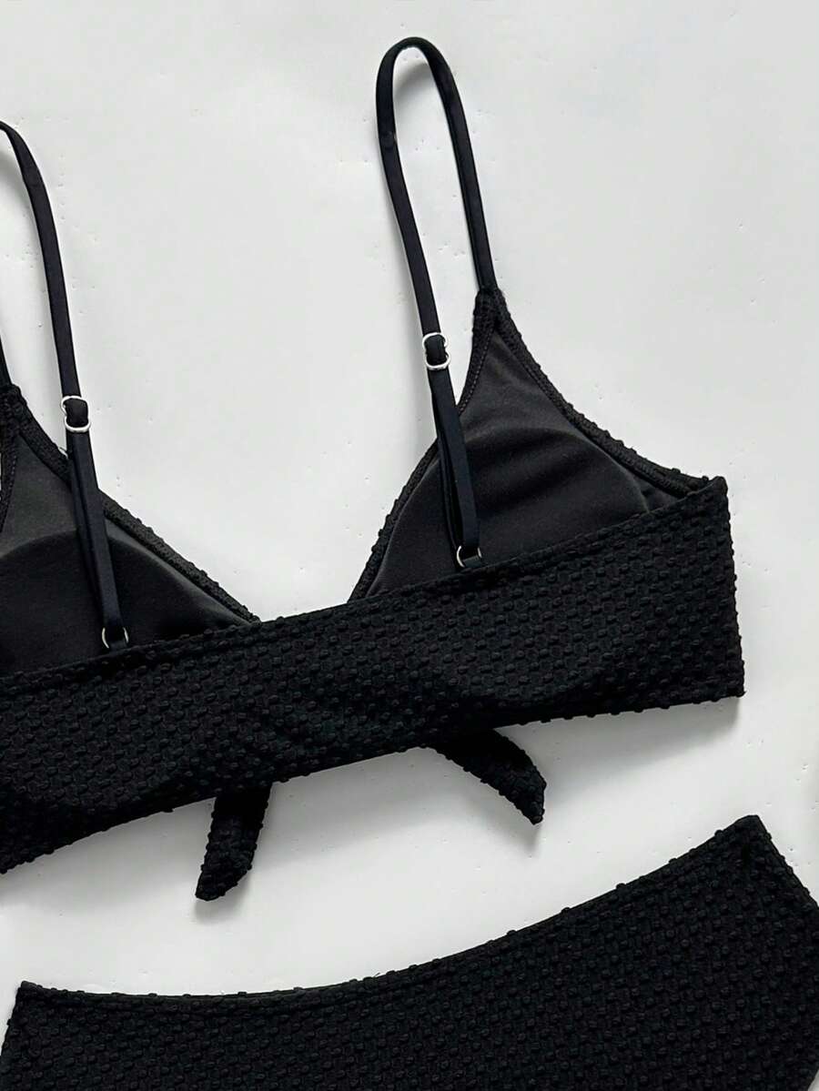 Women's black 2-piece high waist bikini swimsuit set featuring spaghetti straps, criss-cross knot details, wireless bra with removable padding, and high-stretch fabric.