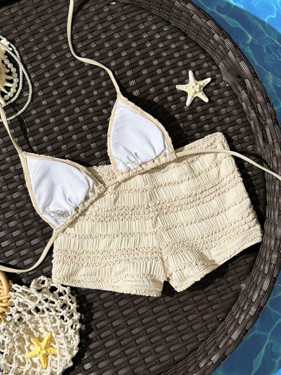 Women's apricot two-piece swimsuit set with a halter tie-back top and matching high stretch shorts.