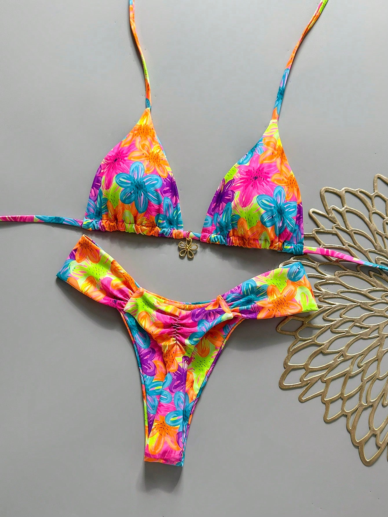 Women's 2-piece triangle cup bikini set in solid color featuring woven pearl shell decoration, halter neckline, and high-waist side-tie ruched bottoms.