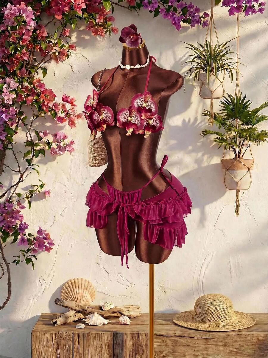 Women's 3-piece blue bikini swimwear set featuring a crop top with 3D rose accents, tie back detail, spaghetti straps, and tie-side bottoms.