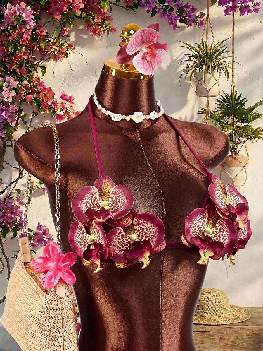 Women's 3-piece blue bikini swimwear set featuring a crop top with 3D rose accents, tie back detail, spaghetti straps, and tie-side bottoms.