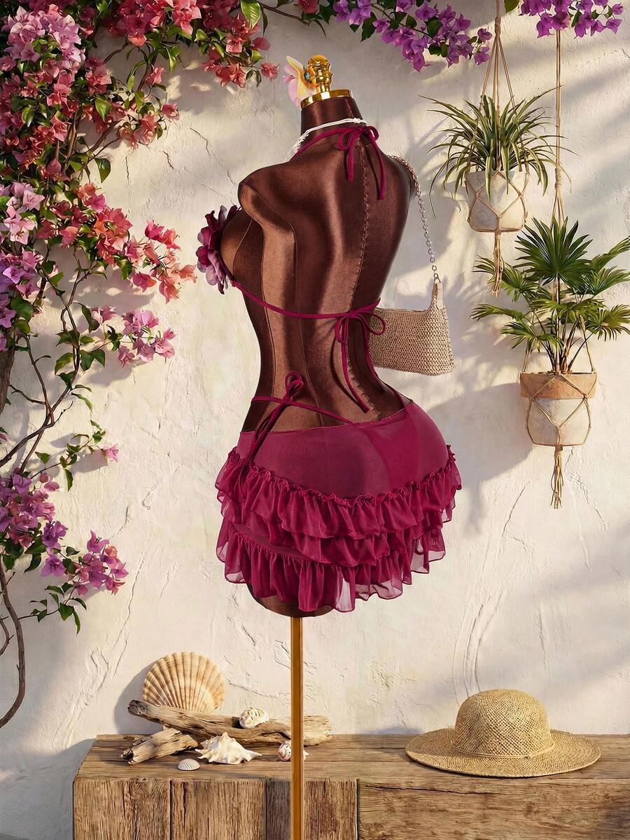 Women's 3-piece blue bikini swimwear set featuring a crop top with 3D rose accents, tie back detail, spaghetti straps, and tie-side bottoms.