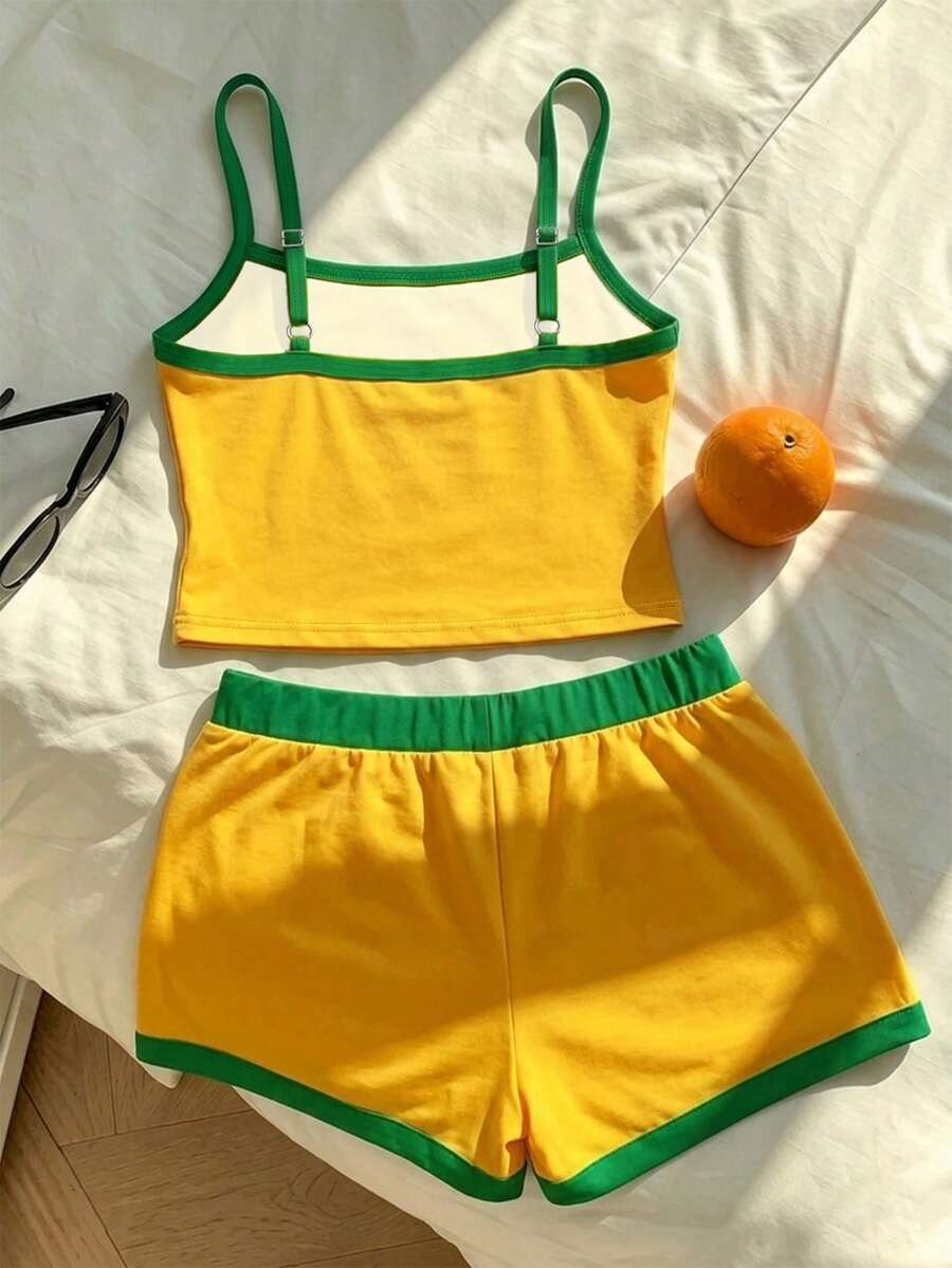 Tween girls summer 2-piece Hawaiian style outfit featuring a graphic print spaghetti strap camisole top with contrast piping and matching casual shorts.