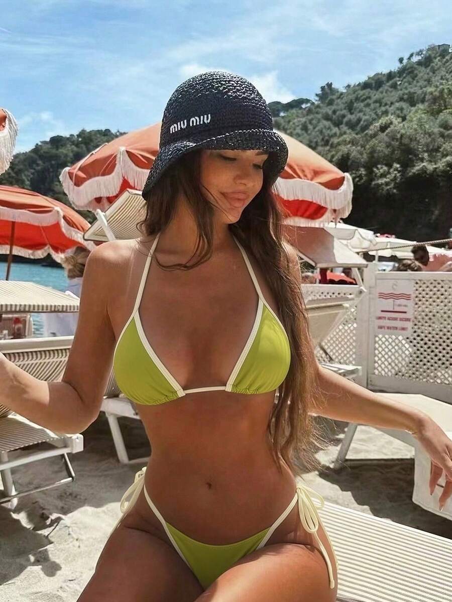 Women's two-piece halter triangle bikini set featuring a backless tie-back top with removable padding and matching tie-side mid-waist bottoms.
