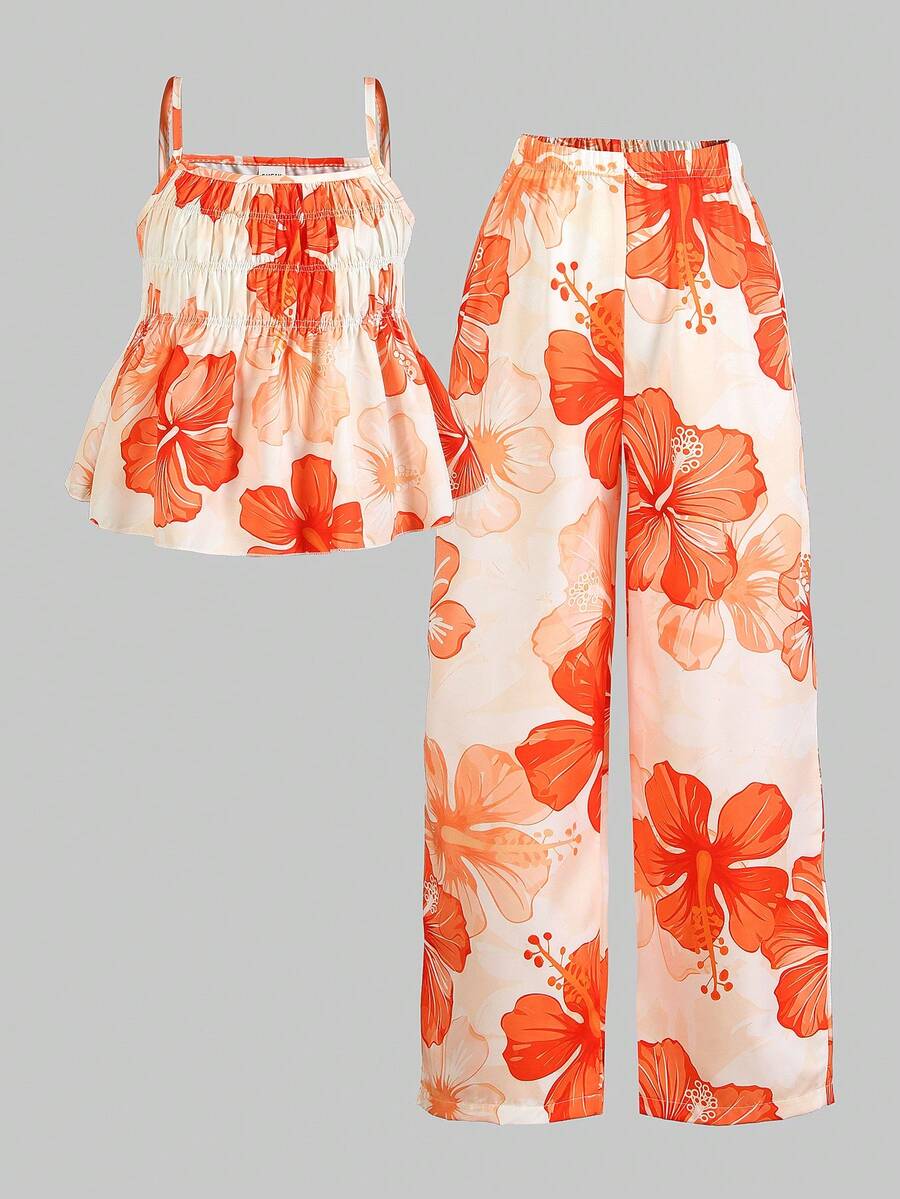 Tween girl wearing an apricot 2-piece outfit set featuring a shirred spaghetti strap short cami top and matching wide-leg long pants.