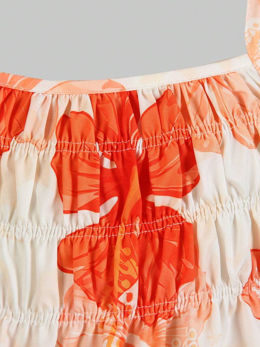 Tween girl wearing an apricot 2-piece outfit set featuring a shirred spaghetti strap short cami top and matching wide-leg long pants.