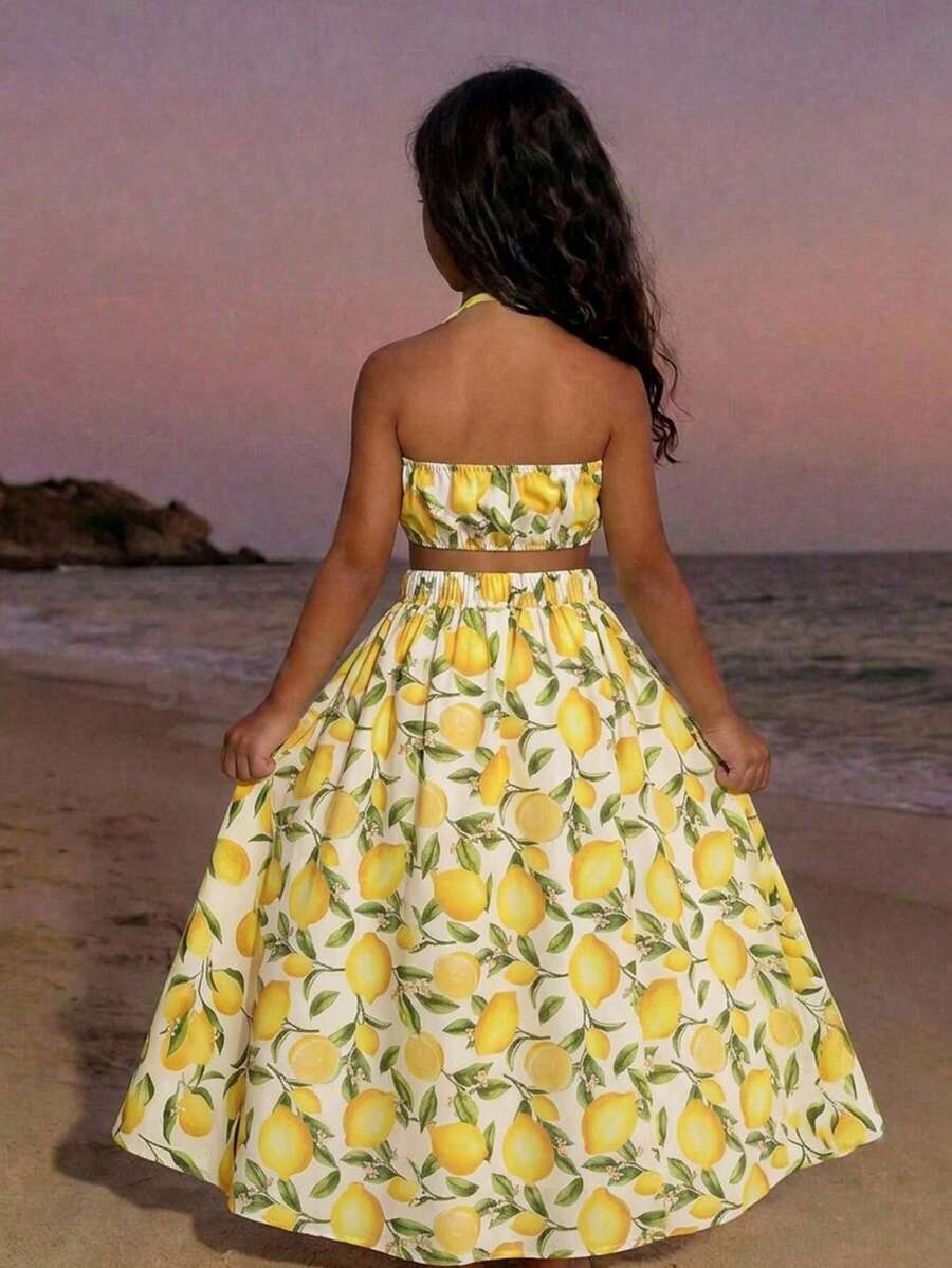 Tween girls floral halter dress with backless sleeveless design, belted high waist, shirred details, appliques, and flared A-line midi silhouette for summer vacation or graduation outfit.