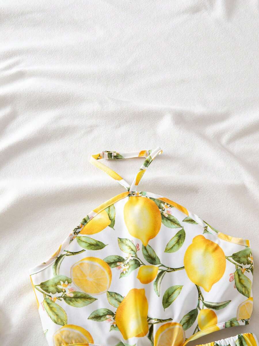 Tween girls floral halter dress with backless sleeveless design, belted high waist, shirred details, appliques, and flared A-line midi silhouette for summer vacation or graduation outfit.