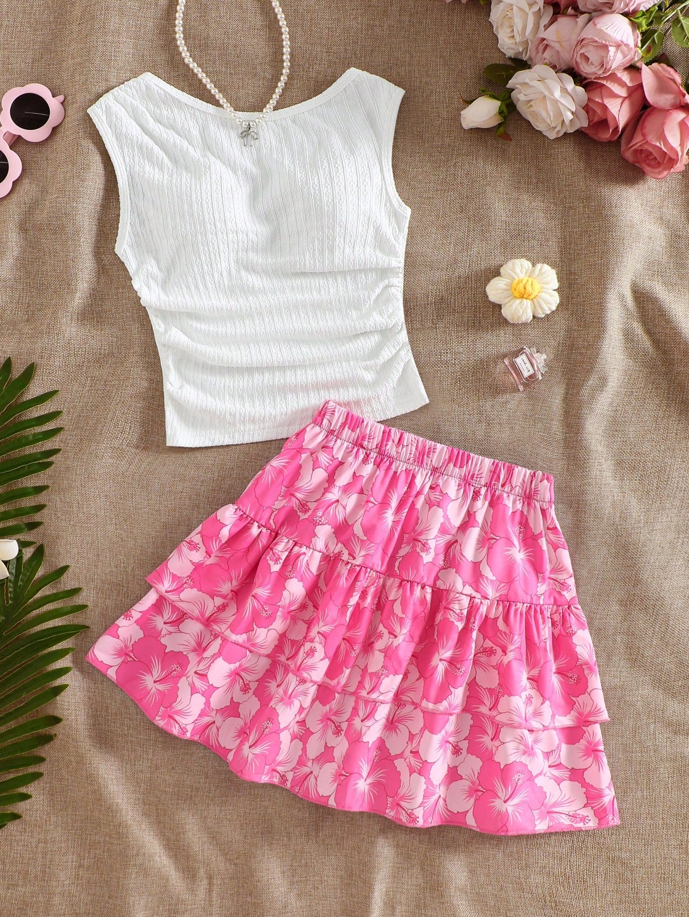 Light blue two-piece outfit set for tween girls with a sleeveless round neck vest top and a tiered ruffle cake skirt featuring a plant pattern.