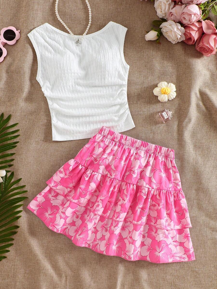 Light blue two-piece outfit set for tween girls with a sleeveless round neck vest top and a tiered ruffle cake skirt featuring a plant pattern.
